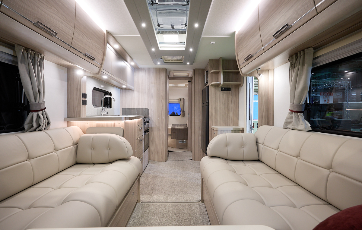 Elddis Crusader Zephyr interior, cream upholstery, light wooden furniture, lounge, kitchen, bedroom, fixed island bed, three skylights