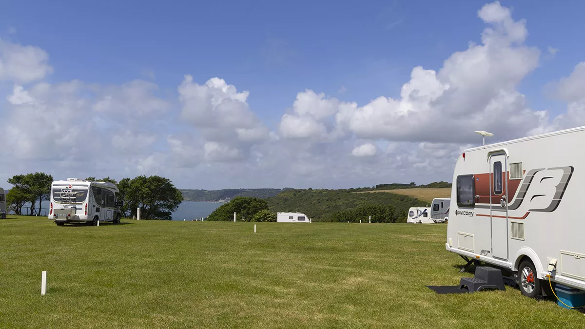 Campsite layout with fields and the sea in the background