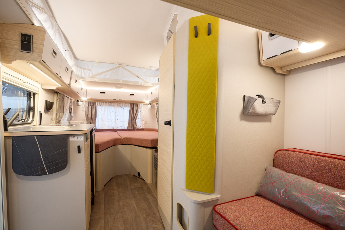 Eriba Touring 542 interior, salmon upholstery, lounge, kitchen, fixed bed