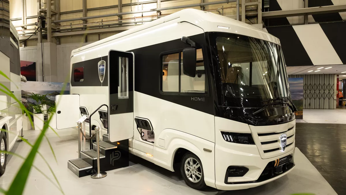 The MORELO HOME 78L has a black and white exterior.  Its habitation door is open and there are three steps to gain easy access.  The rear garage locker is open