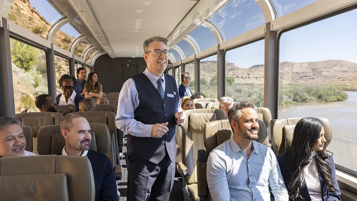 Interior shot of the Rocky Mountaineer with people enjoying the views