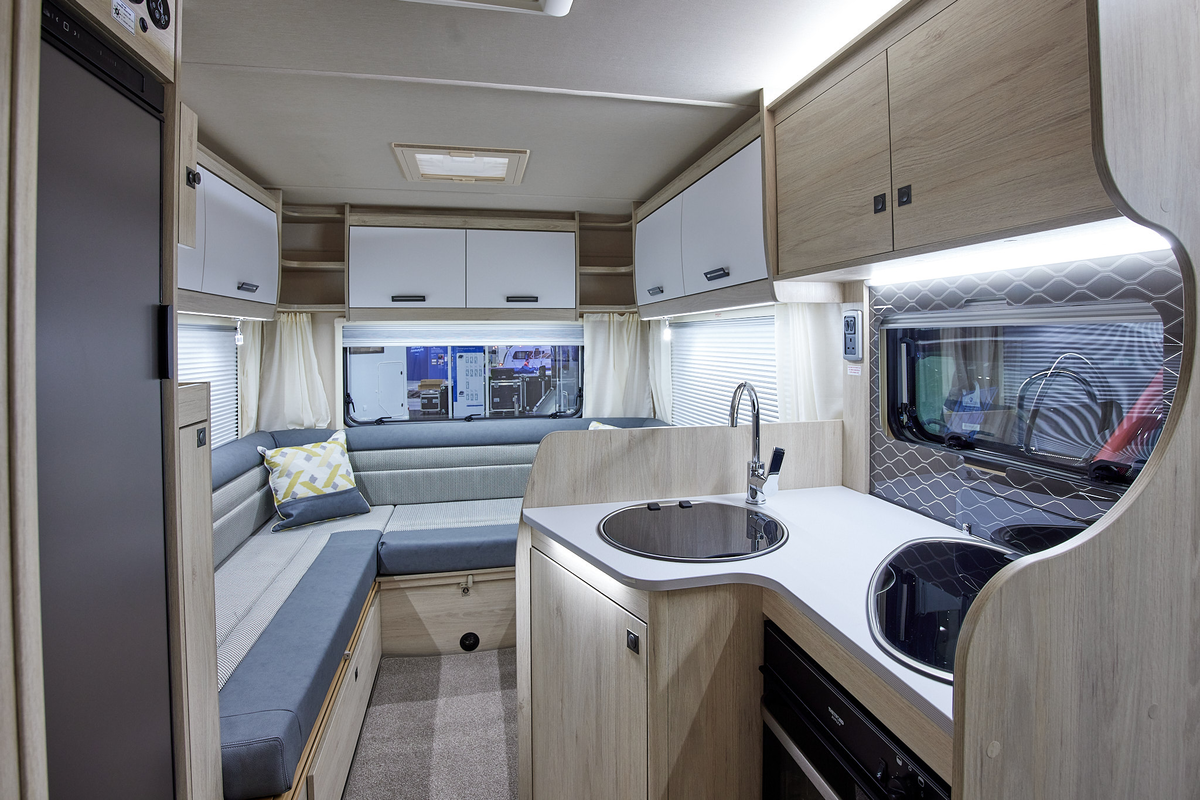 Coachbuilt interior, grey and cream upholstery, wood and cream furniture