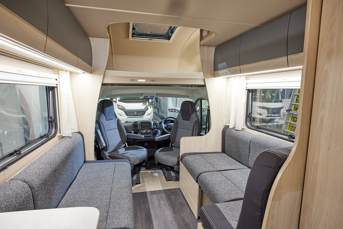 Coachbuilt interior, grey upholstery, wooden furniture
