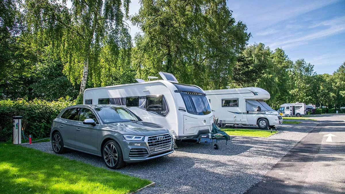 A caravan and a motorhome parked on serviced hardstanding pitches