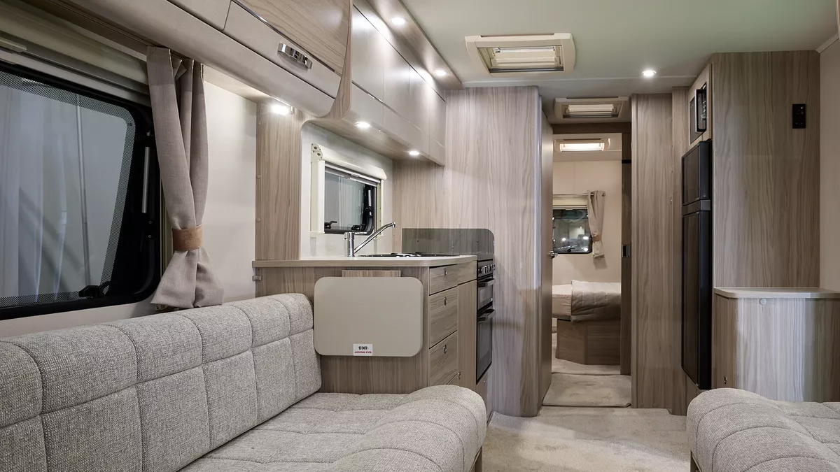 Elddis Avanté 860 interior, beige upholstery, wooden furniture, lounge, kitchen, bedroom, fixed island bed, three skylights
