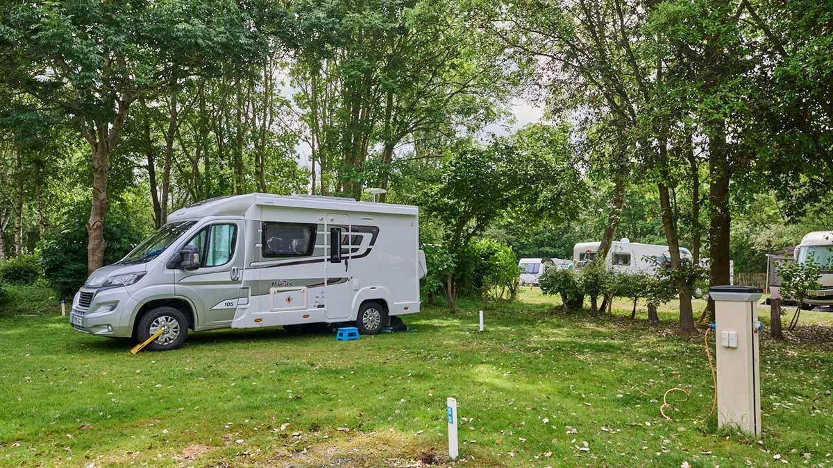 Motorhome on a shady grass pitch