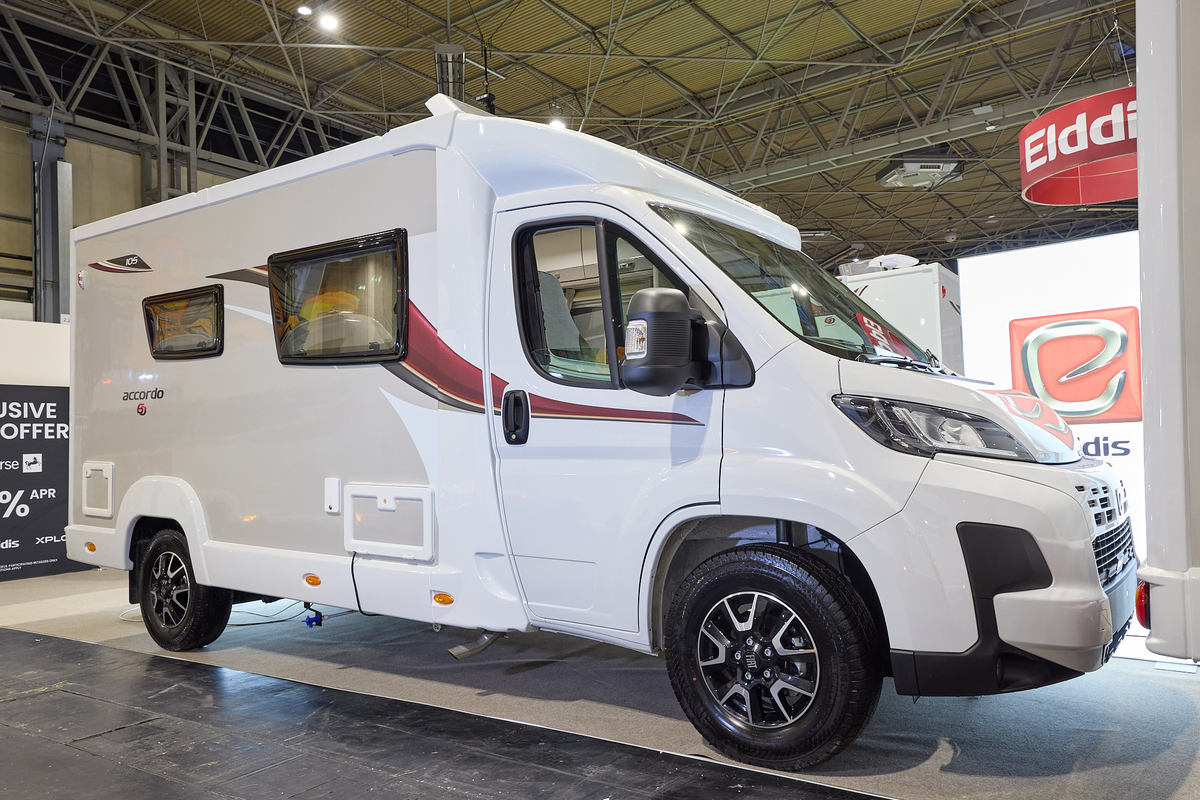 The Elddis Accordo 105 has a white body with a grey side panel.  There are red and black decals.  