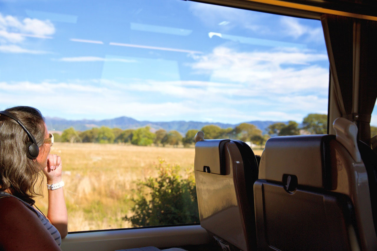Photo of woman looking out of train window in New Zealand