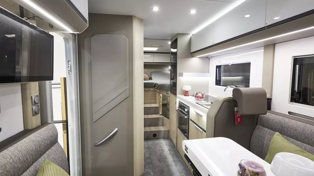 Grey upholstery, white overhead lockers, lime cushions