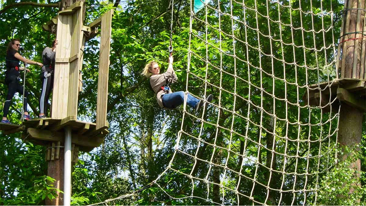 Woman on Go Ape climbing obstacle course