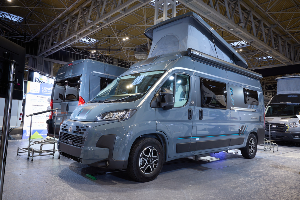 The Swift Carrera 244 is grey with black trim, it's habitation step is extended.  The rising roof is fully extended.
