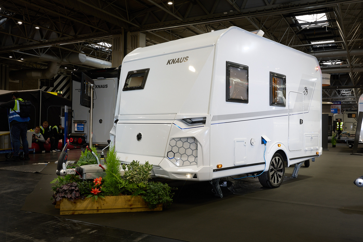 Knaus Yaseo 340 PX exterior is white and it has a small square front window in the left hand middle panel.  There are grey honeycomb patterned panel at the front.. 