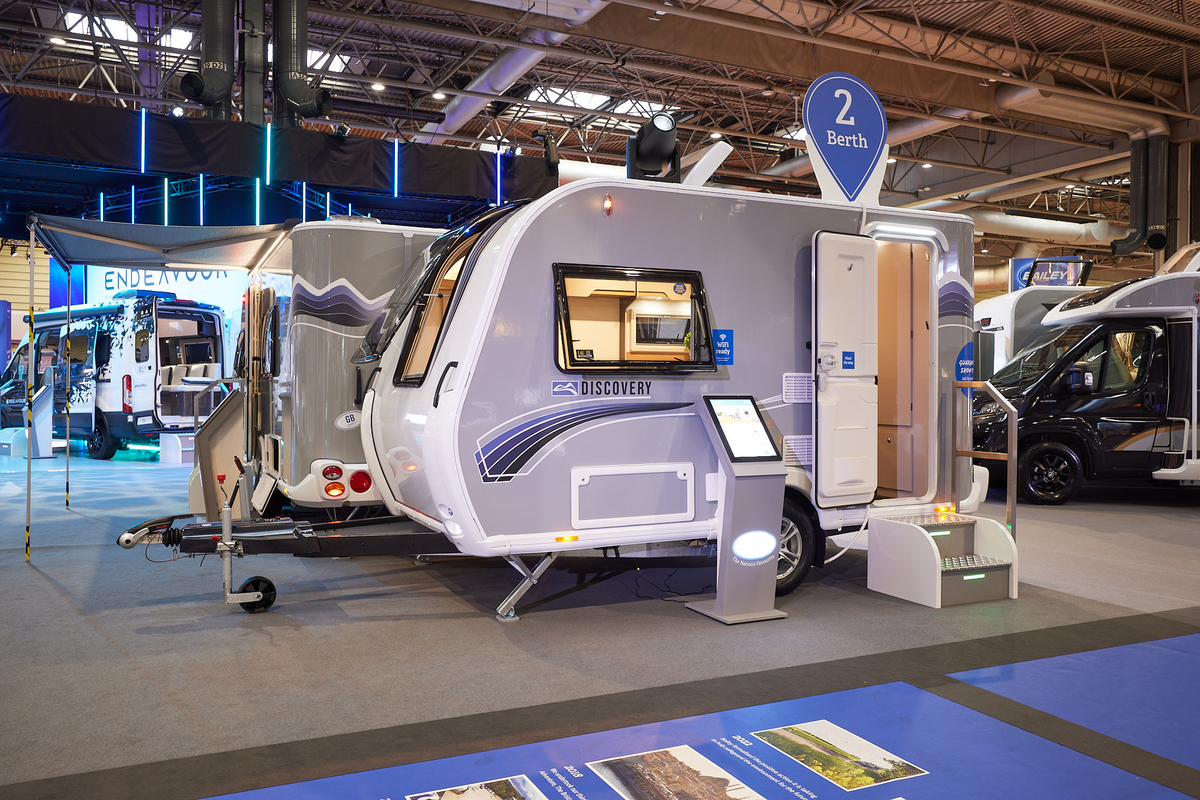 Bailey Discovery D4-2 exterior which is pale grey.  The door is open and there are steps to gain easy access to the interior.  The round sticker on the roof advises the audience it is a two berth.