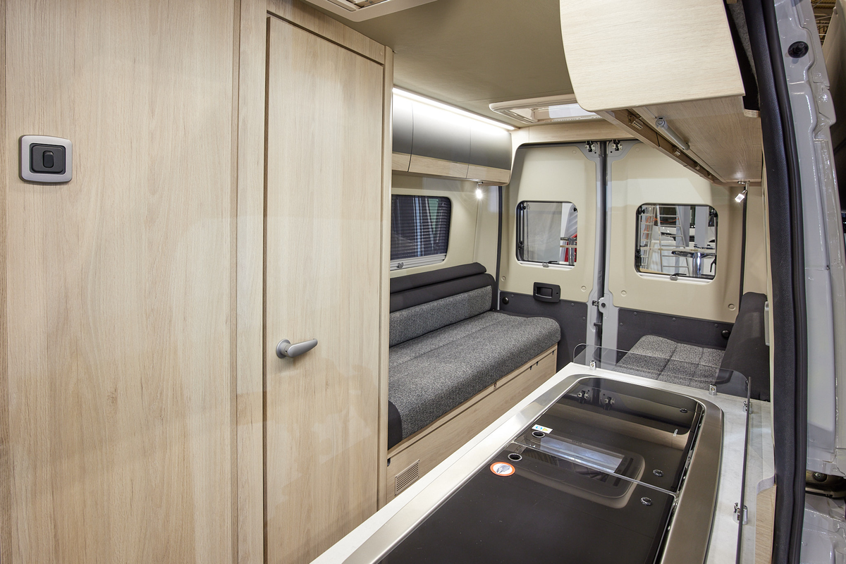 Van conversion interior, wooden furniture, grey upholstery