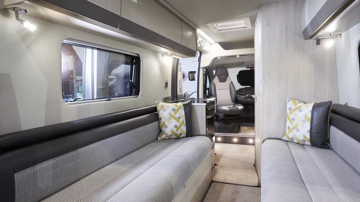 Interior, two tone grey sofas, patterned cushions, ground level lighting