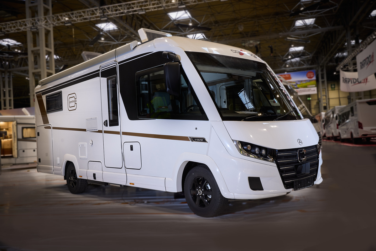 The Carthago C2-tourer I 148 RB-QB is white with gold decals.  The two skylights are open.