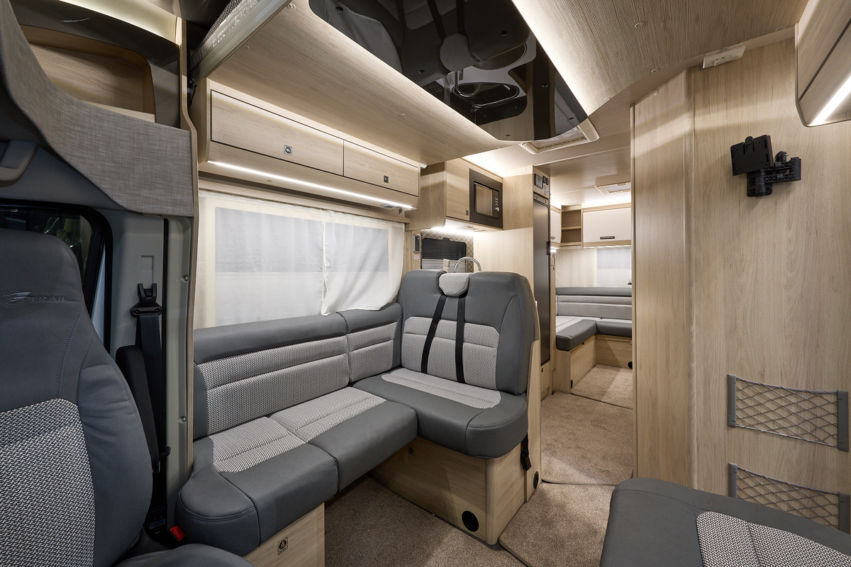 Auto-Trail F-Line F72's interior has two tone grey leather and fabric.  The furniture is wooden and two of the rear seats have fitted seat belts.  There is a lounge to the rear.