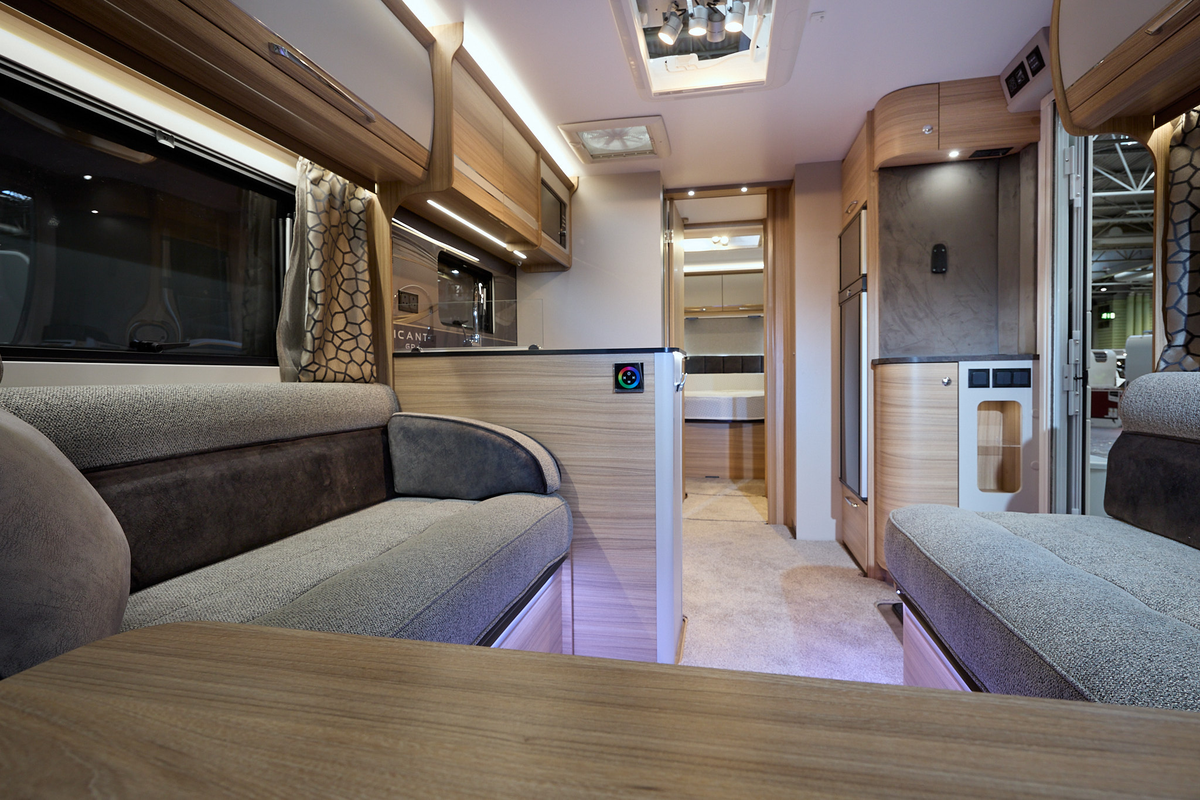 Bailey Alicanto Grande Porto interior, grey upholstery, wood/cream and wood overhead lockers, lounge, kitchen and bedroom, fixed bed, two skylights