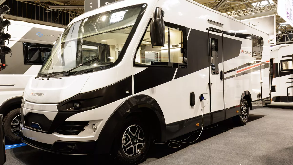 The Roller Team Pegaso 740 has a black and white exterior with a red stripe.