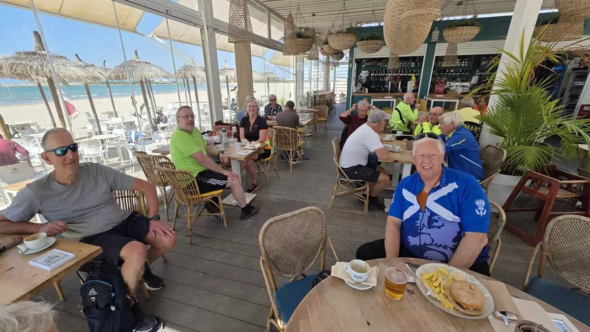 the group enjoying a coffee break by the beach