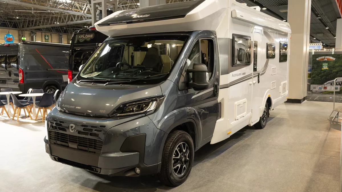 The Elddis Autoquest APEX 196+ has a grey cab and a white coachbuilt body.  It has grey striped decals along the sides.