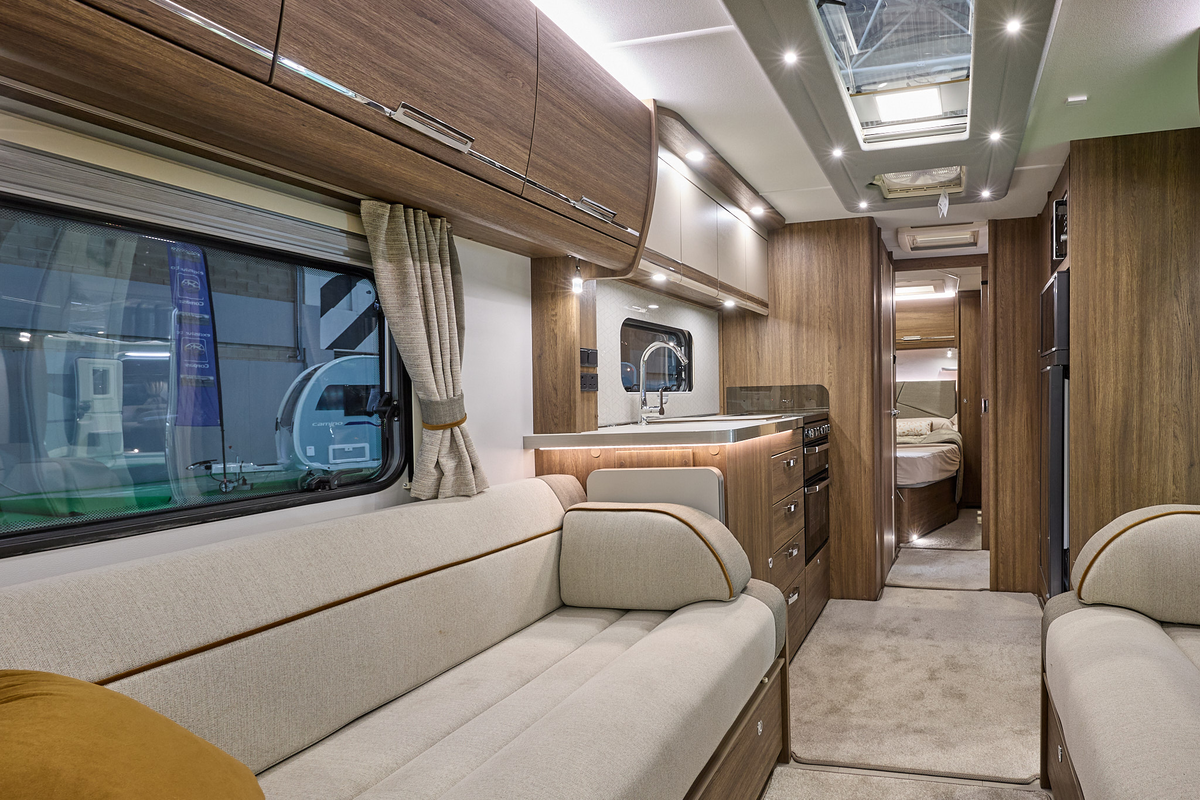 Compass Camino 668 interior, cream upholstery, dark wood furniture, skylights