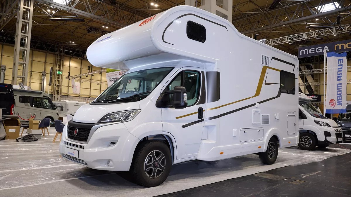 The Eura Mobil Activa One 650 HS has a white body with black and gold decals.  There is a window in the over cab area and another at the rear.