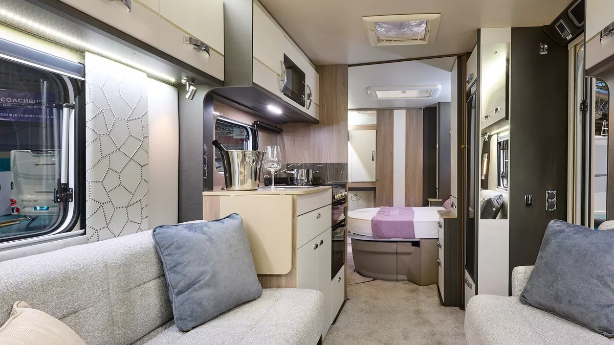 Swift Conqueror 580 interior, cream upholstery, cream lockers, lounge, kitchen, fixed bed, skylights