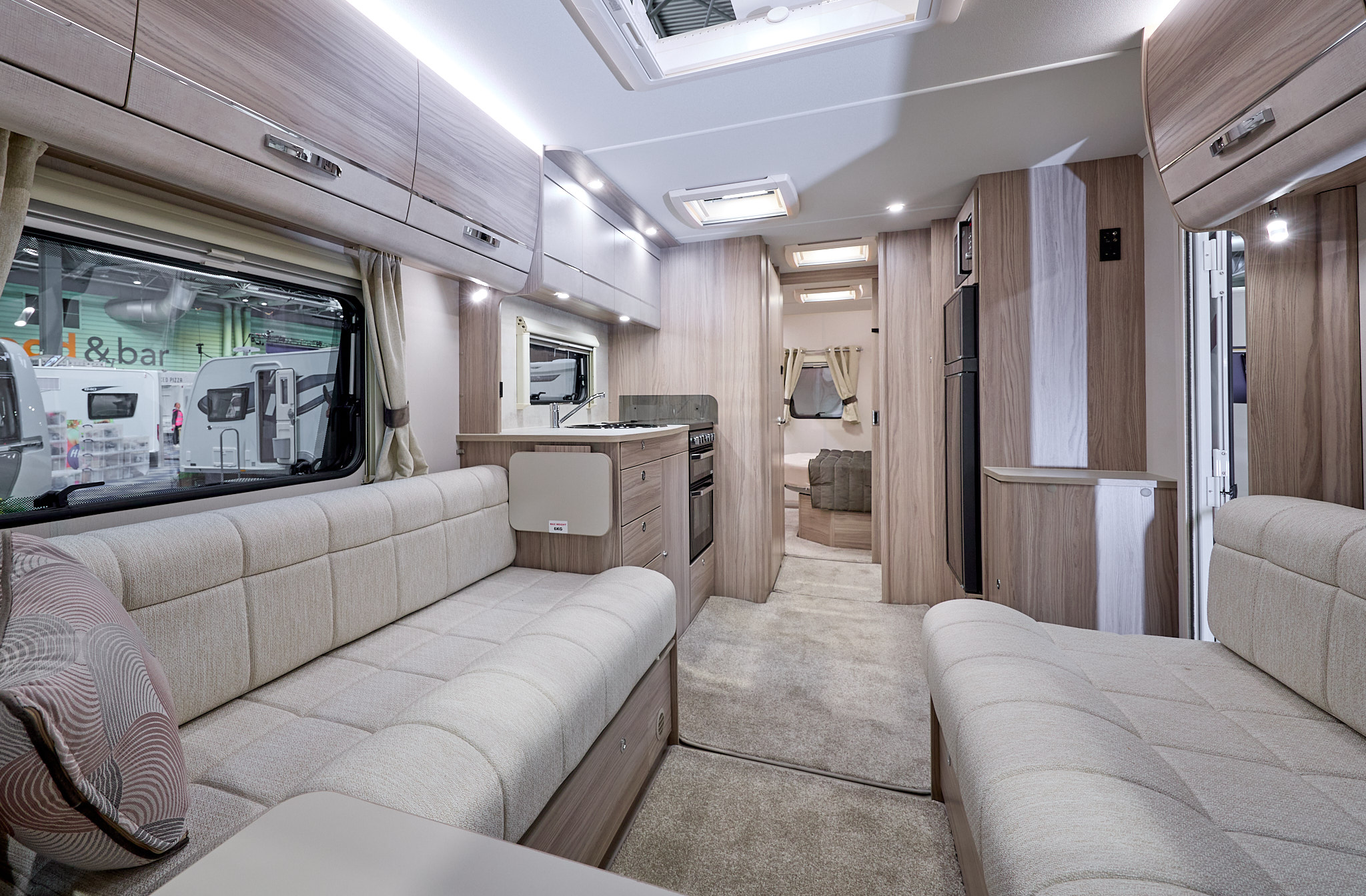 Elddis Avante 860's interior has pale wood furniture and its upholstery is cream.  The bedroom is to the rear and it has a large skylight.