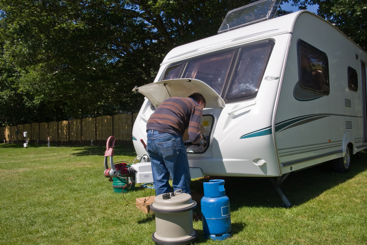 Man setting caravan ready for holiday