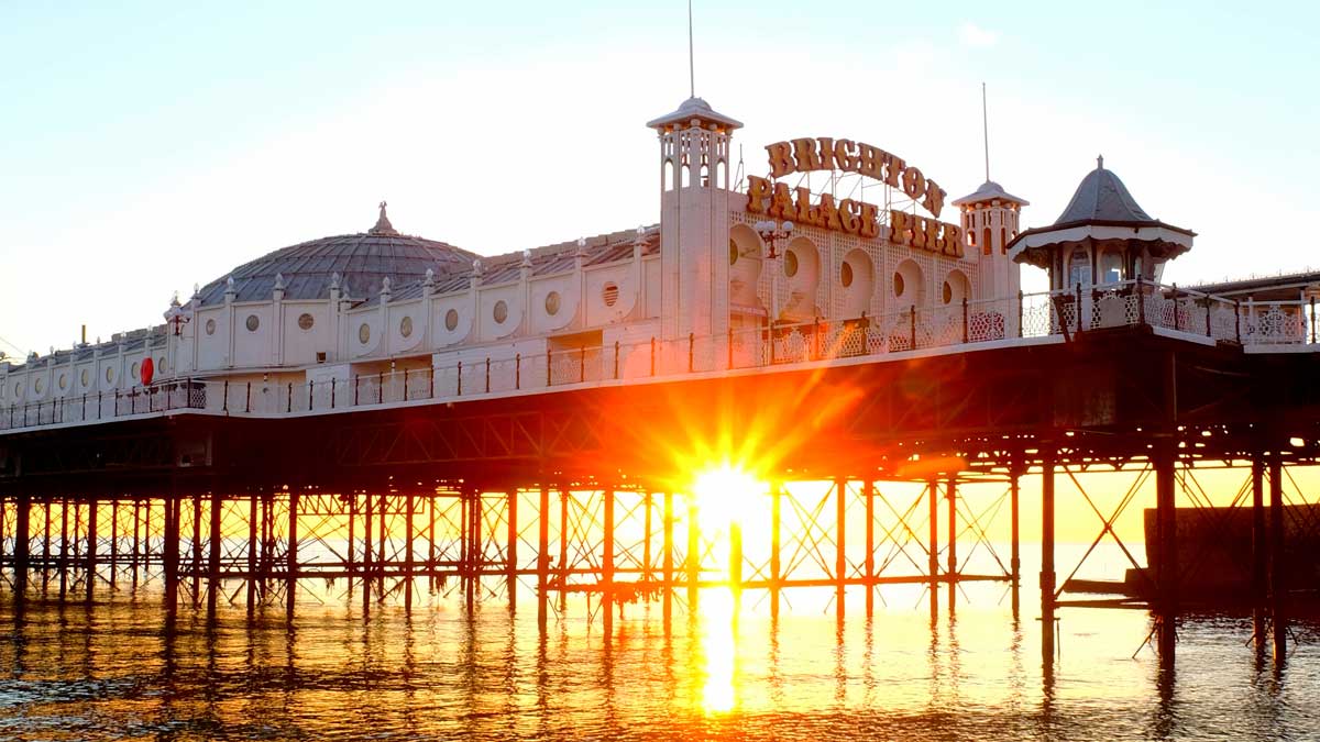 Sunset shining under Brighton Palace Pier