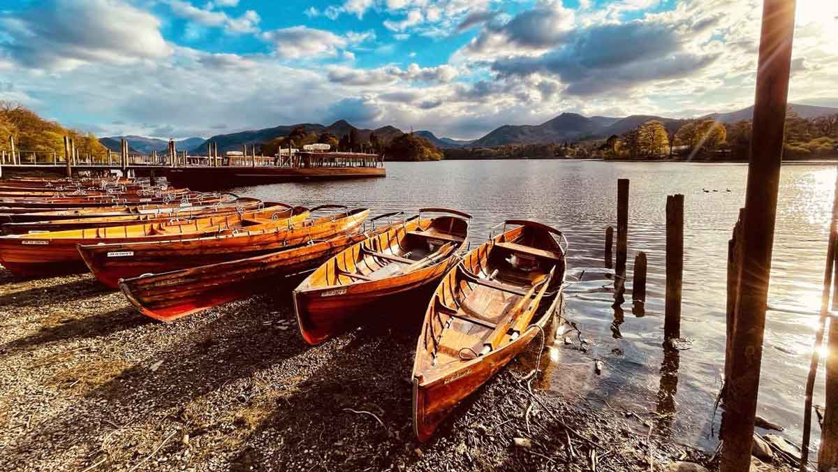Wooden boats on shingle beach at the edge of the water