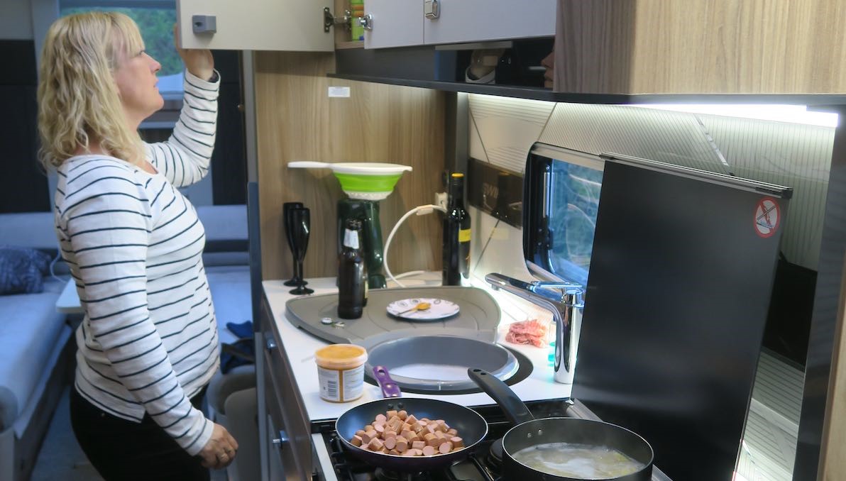 Practical expert Sammy Faircloth checks a caravan locker in a kitchen