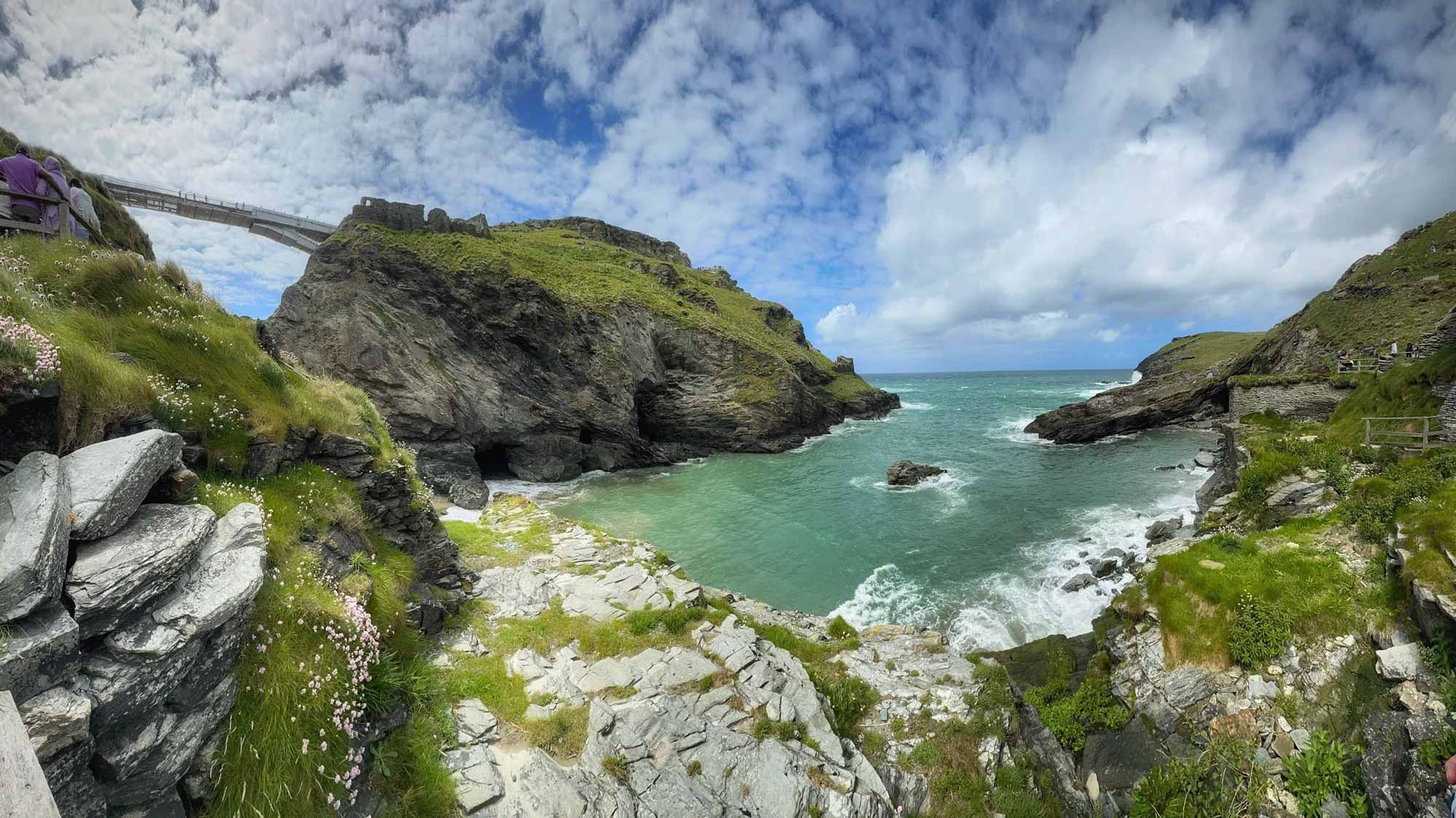 looking out to sea with clear turquoise water and the rocky Cornwall coast