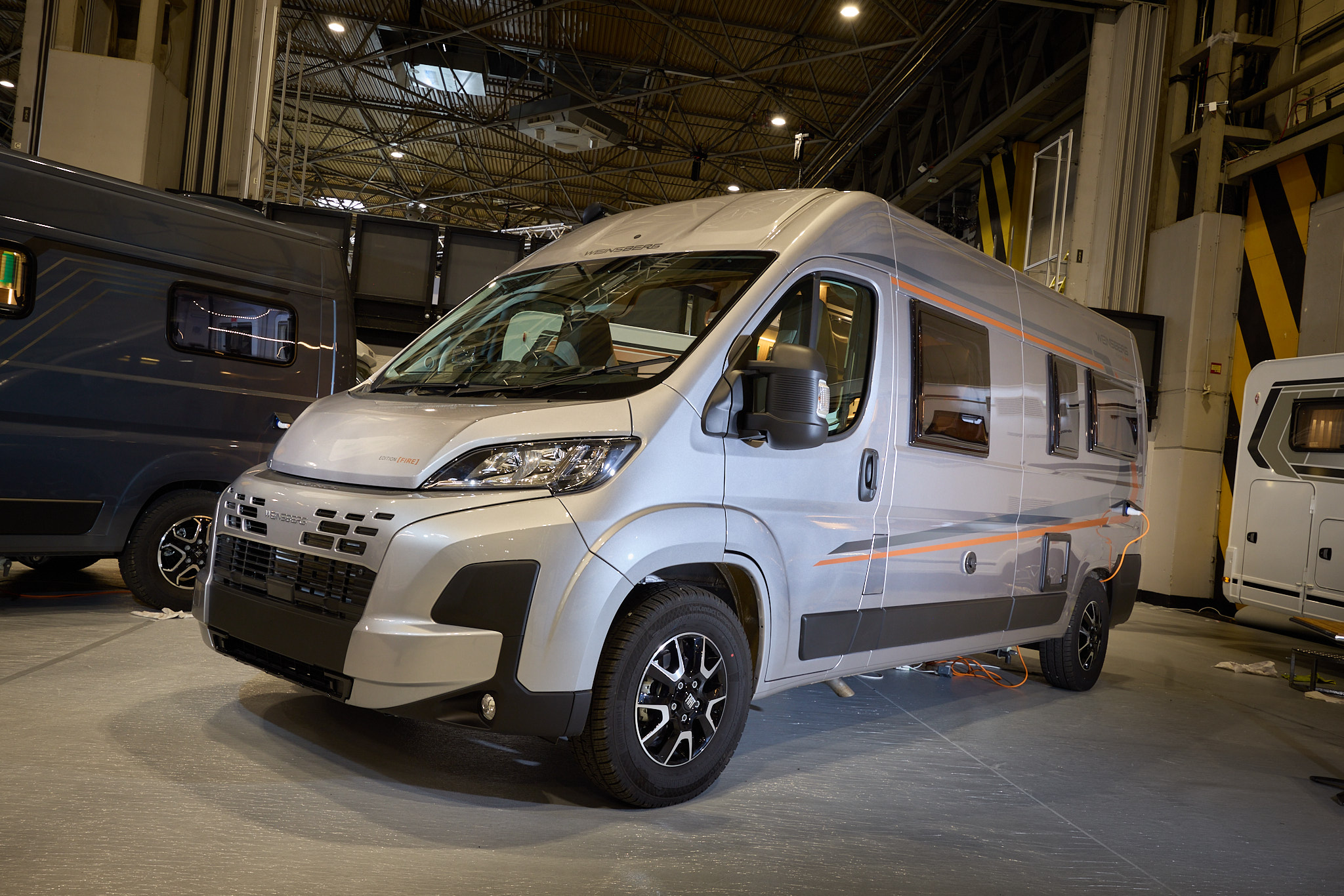 Weinsberg CaraBus 600 MQ Edition FIRE is sliver with black trim.  It has grey and orange decals.