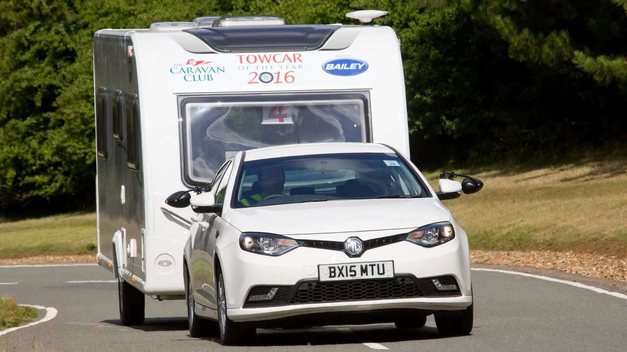 White MG towing a white caravan