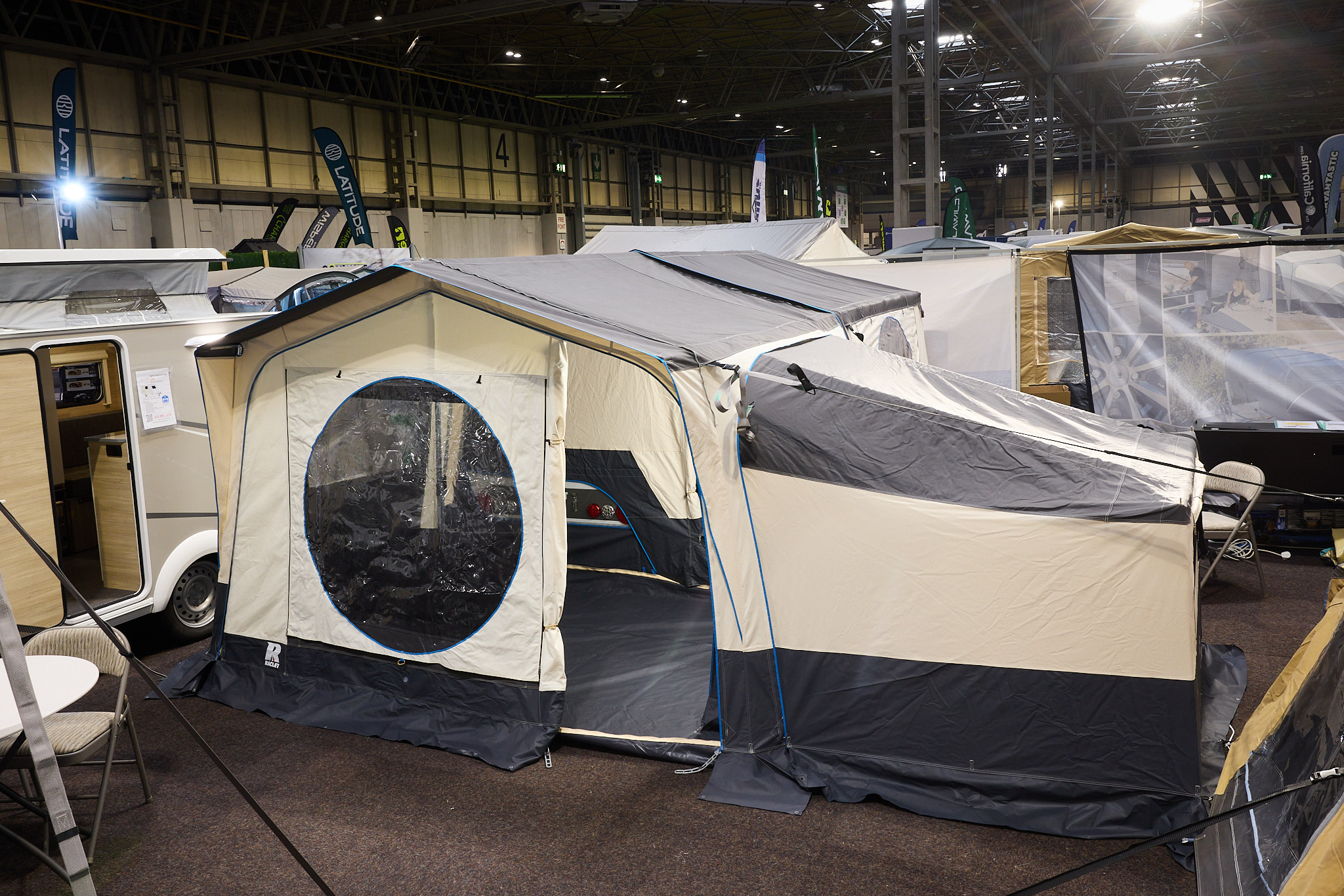 The Raclet Solena 2.1 has a grey roof with cream walls.  The entrance door is open revealing the interior.