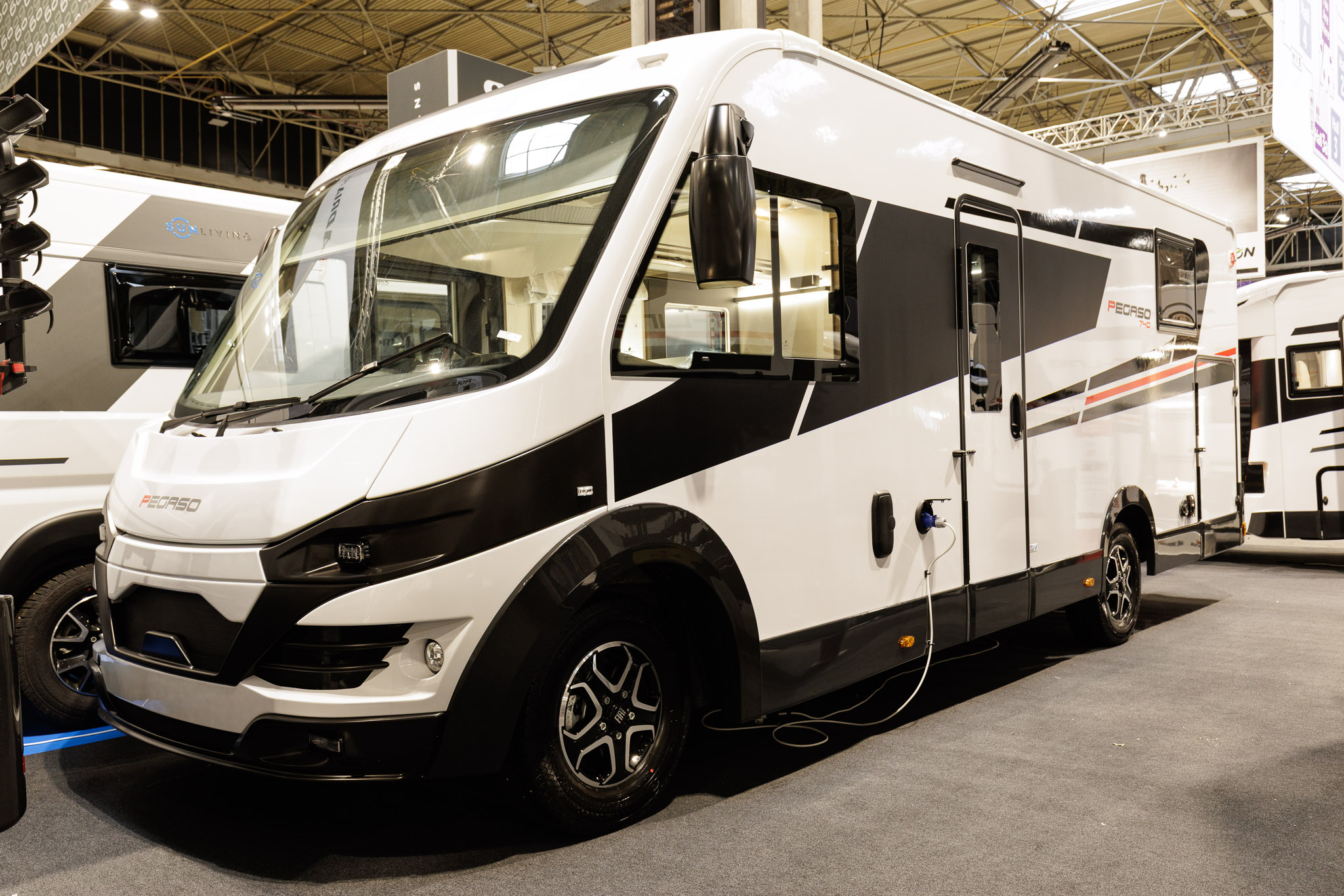 The Roller Team Pegaso 740 has a black and white exterior with a red stripe.