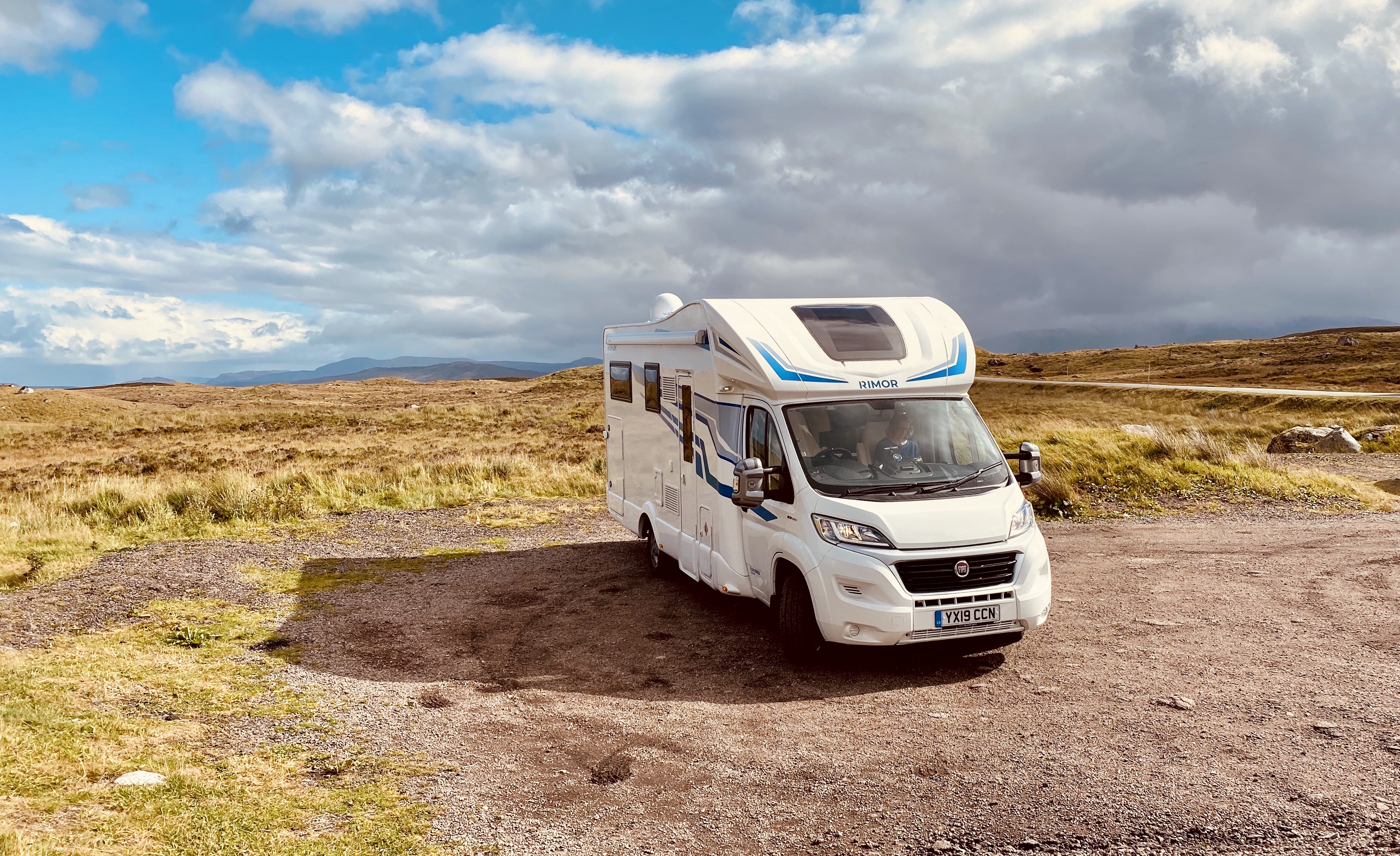 White motorhome parked on grassy land