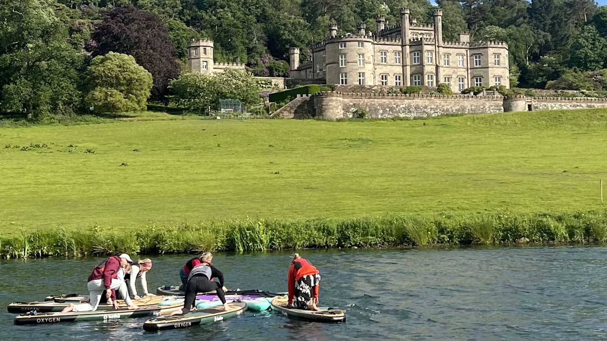 trying out paddleboarding in front of the Castle