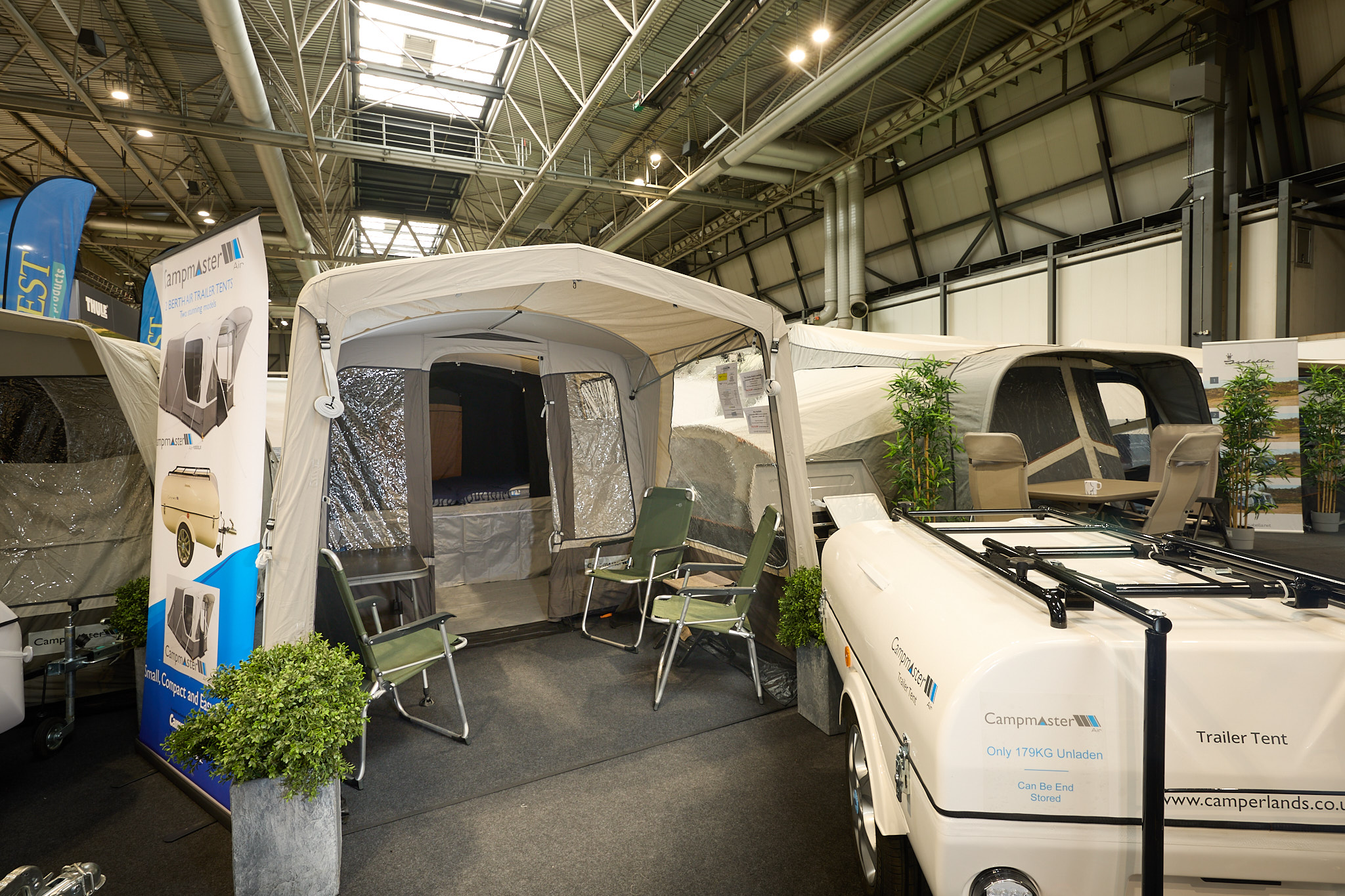 Campmaster AIR 600 LX exterior, cream and brown canvas.  There are four lime green canvas chairs.  The travelling trailer is shown in cream 