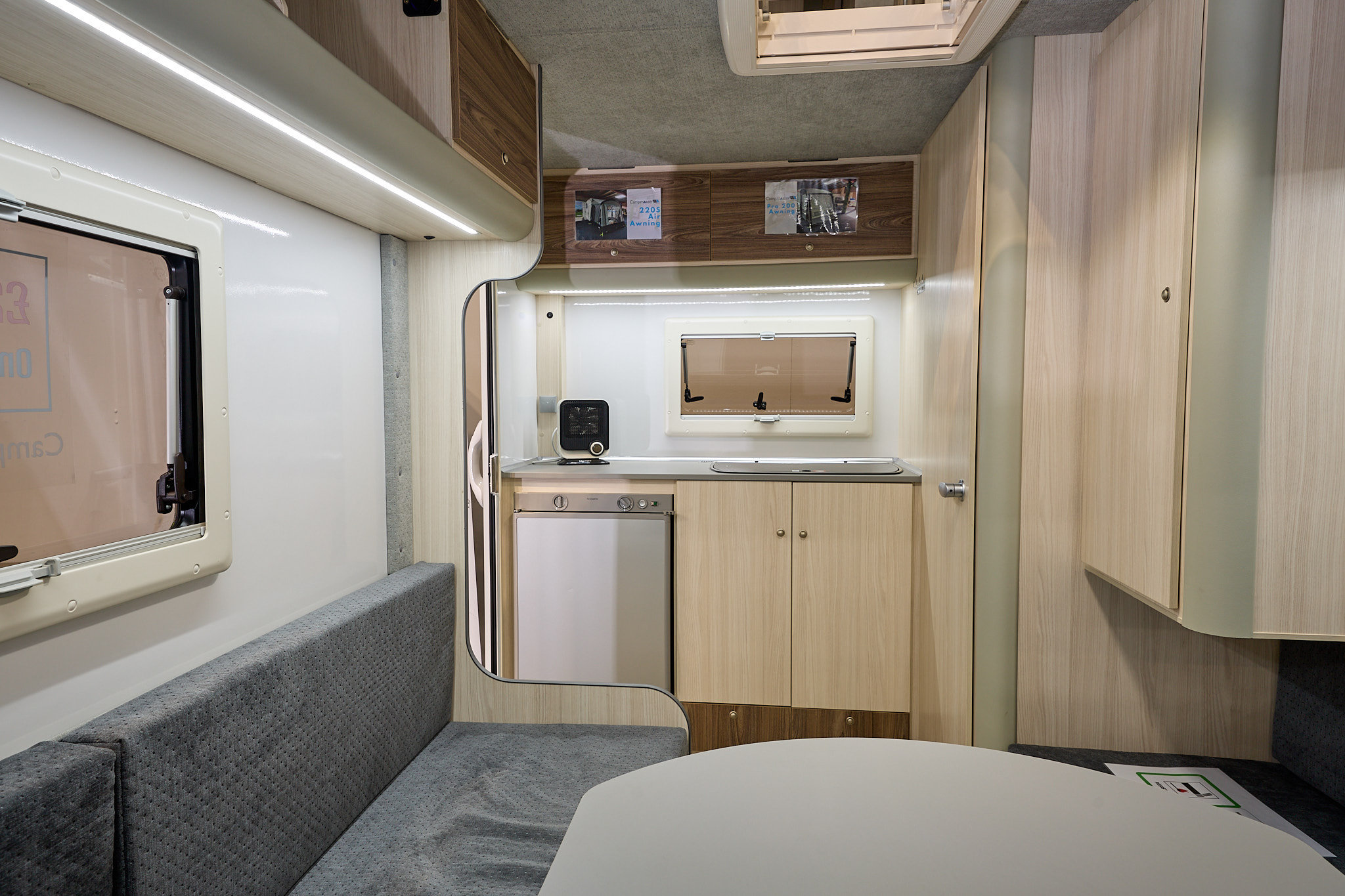 Campermaster King interior, grey upholstery, pale wood furniture, end kitchen