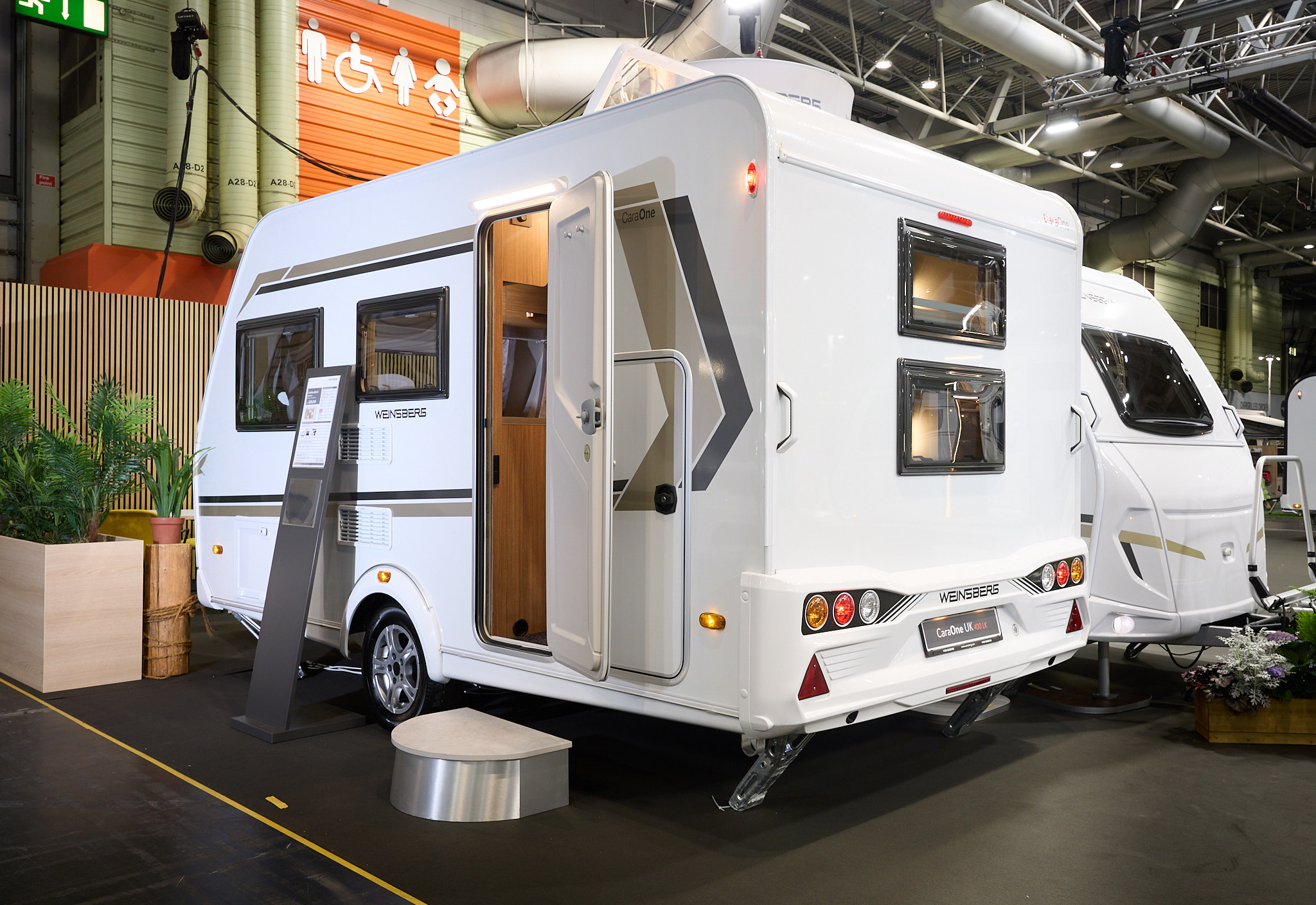 Weinsberg CaraOne 400 LK Bunks' exterior is white with brown and gold graphics.  There are two windows in the rear panel for the bunk occupants to enjoy the view.