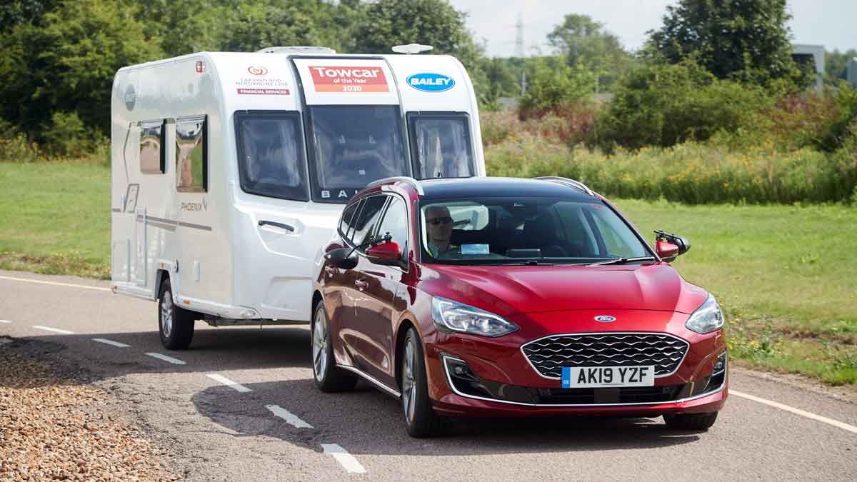 Red Ford Focus towing a caravan