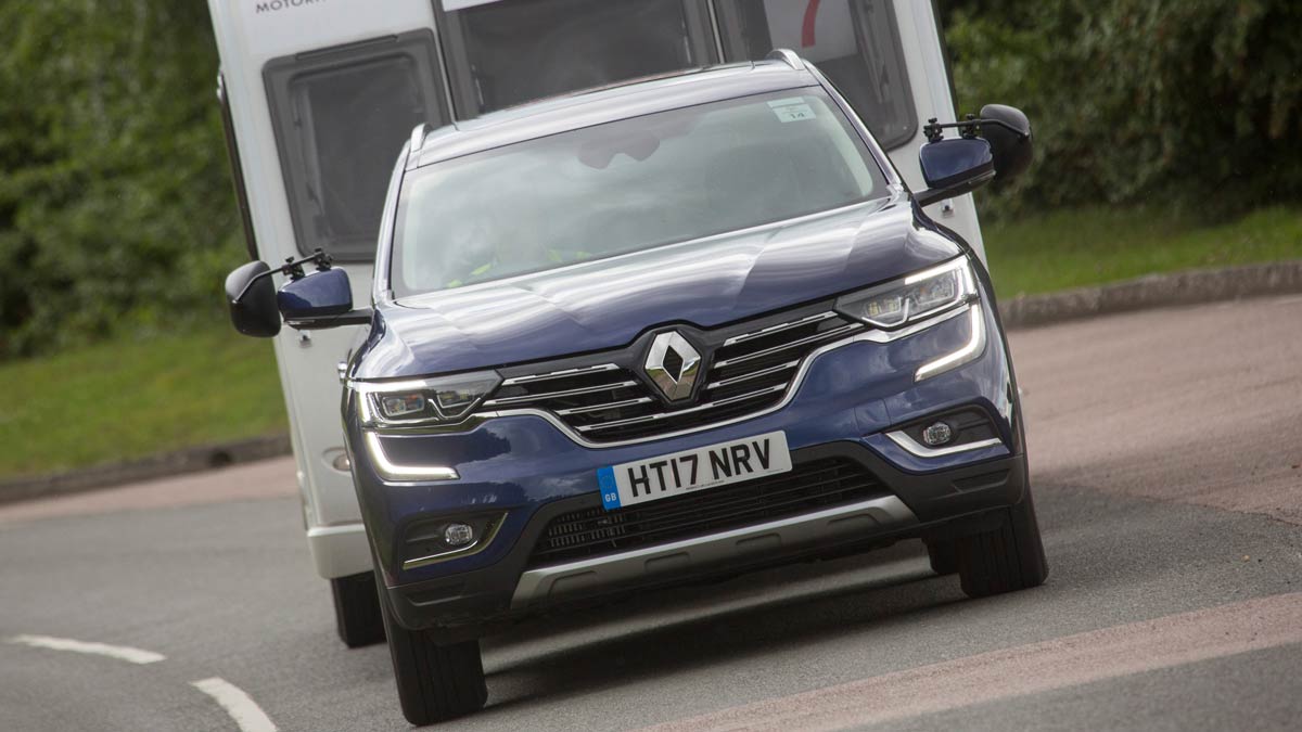 Blue Renault towing a caravan close up