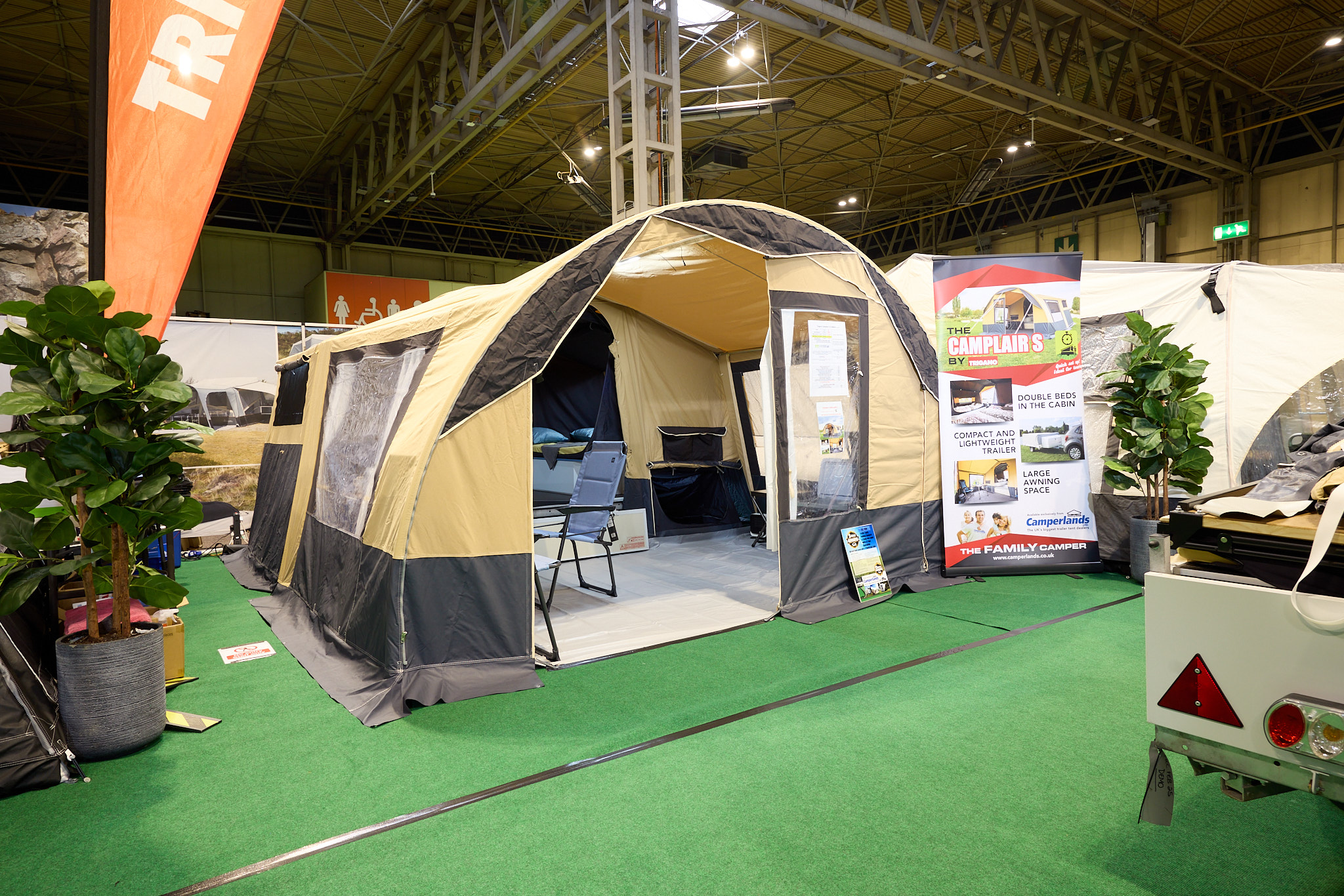 Trigano Galleon Standard's canvas is yellow and brown.  The front door is open, revealing the interior.