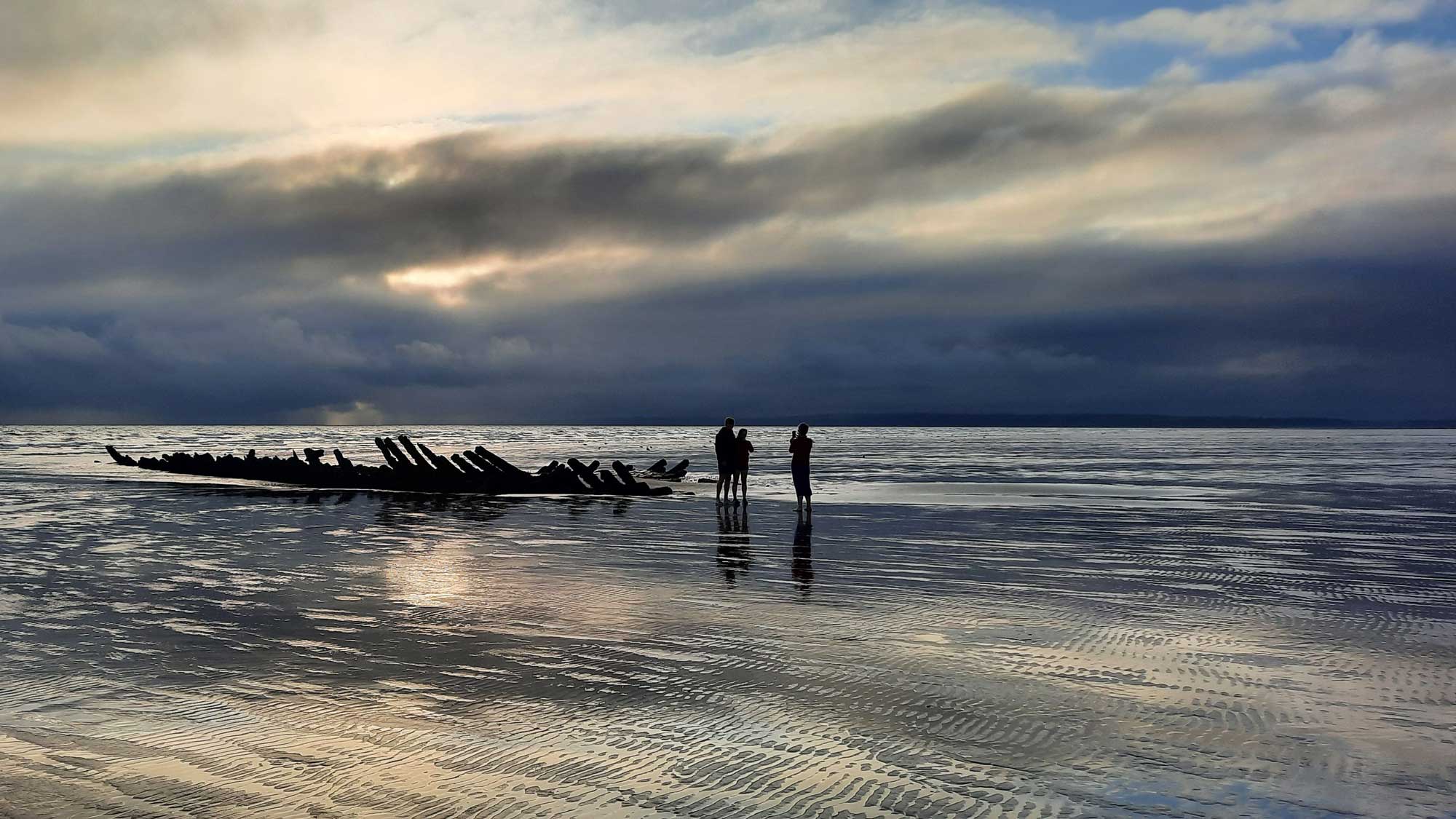 Driftwood on the beach at Pembrey at low tide 