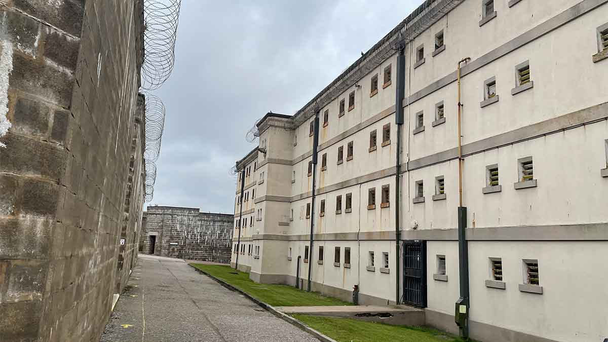Looking along to the big cream coloured 4 storey high building of Peterhead Prison