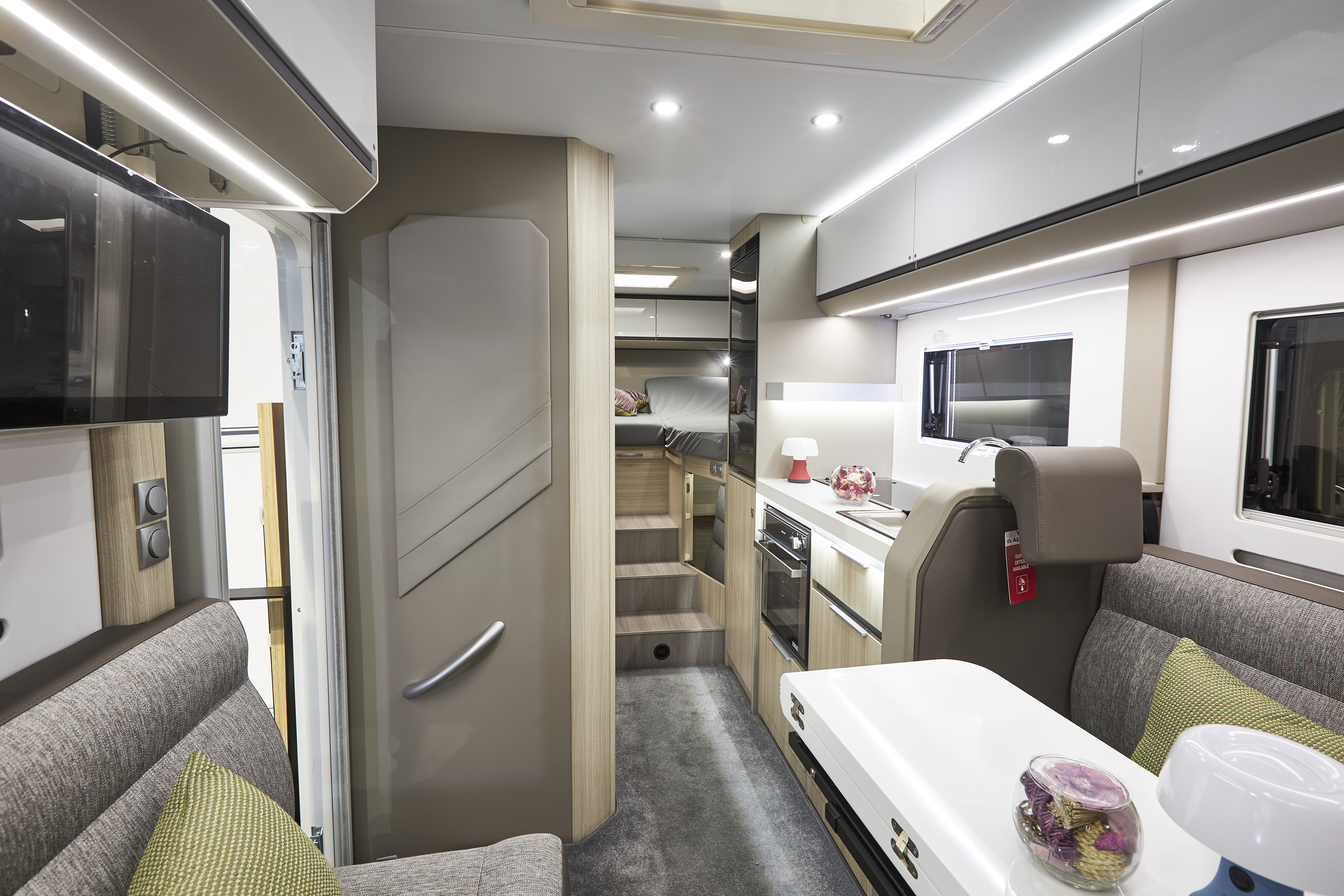 Grey upholstery, white overhead lockers, lime cushions