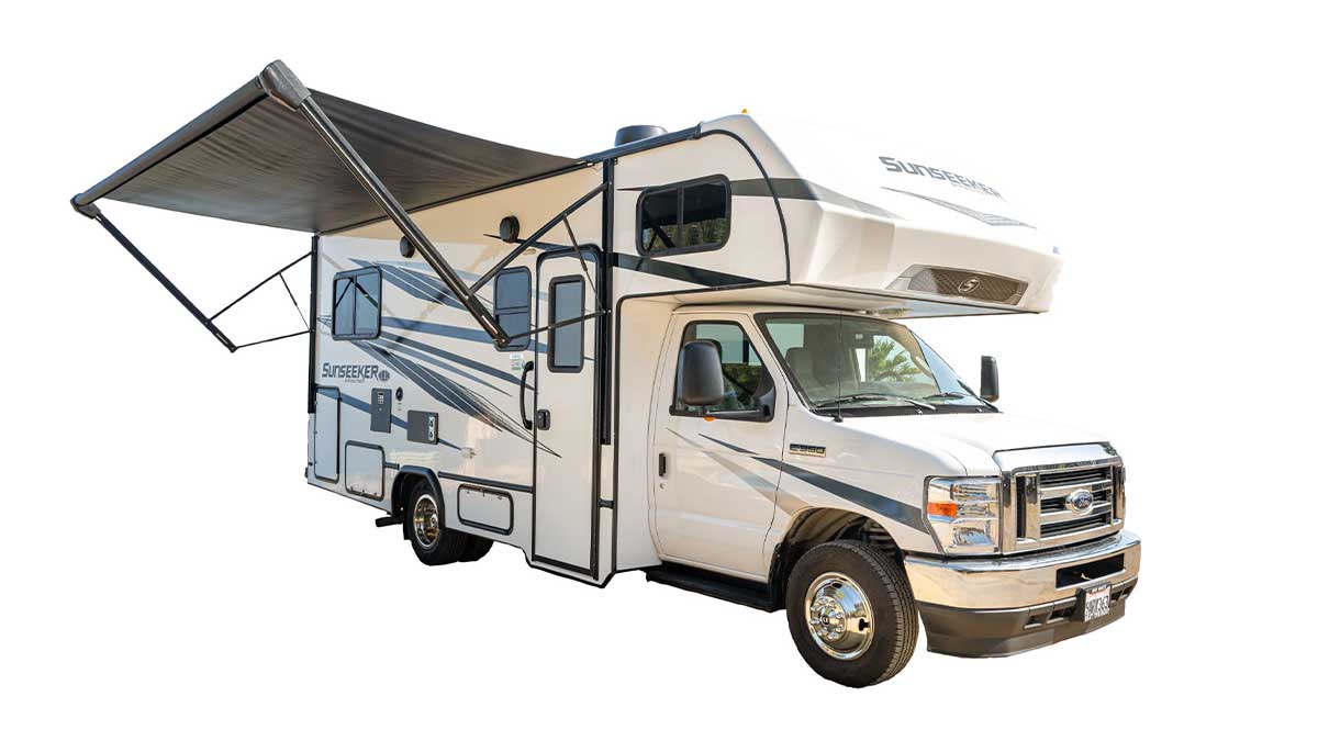 A white with dark colour pattern stripes Road Bear overcab motorhome. Class C 24-26. With an canopy awning pulled out. With a white background. 